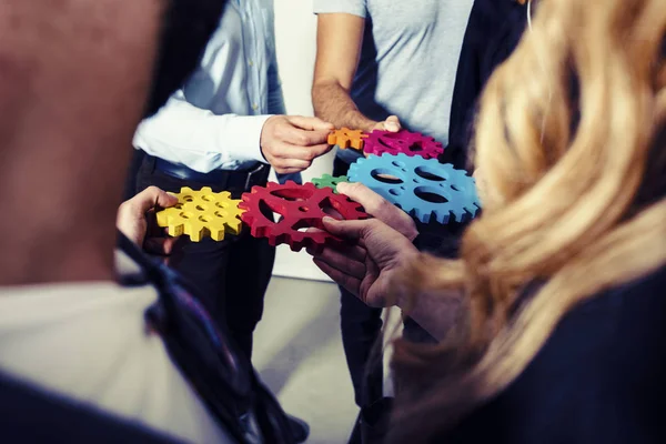 Zakenteam verbinden stukken tandwielen. Teamwork, partnerschap en integratie — Stockfoto