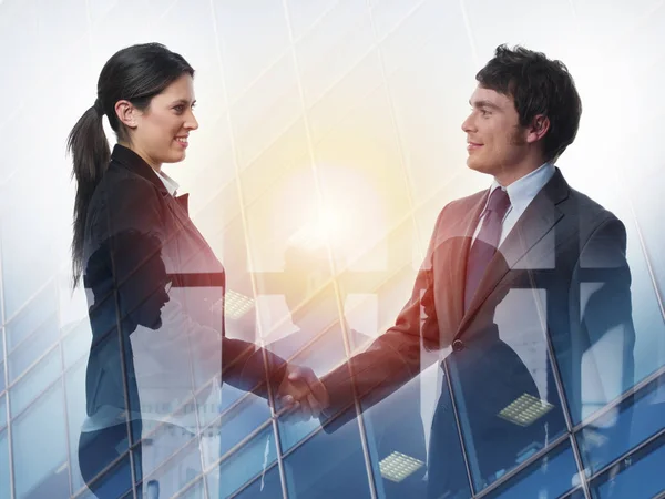 Handshake of two businessperson in office concept of partnership and teamwork.double exposure — Stock Photo, Image