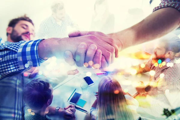 Handshaking business person in casual wear in the office. concept of teamwork and partnership. double exposure — Stock Photo, Image