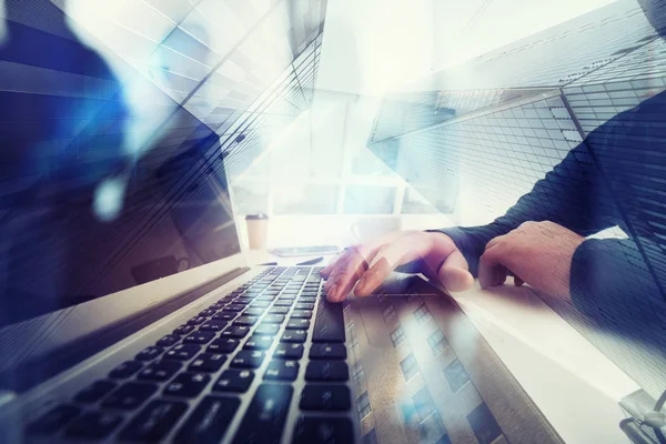 Business man works in office with laptop in the foreground. Concept of teamwork and partnership. double exposure with network effects — Stock Photo, Image