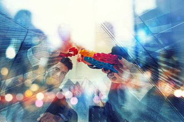 Working group of businessmen find the agreement by holding a piece of gear in hand. concept of teamwork and business partnership. double exposure — Stock Photo, Image