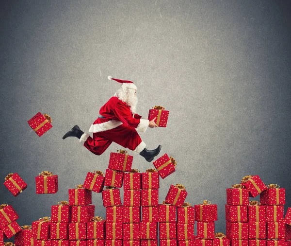 Santa Claus goes fast over Christmas gift — Stock Photo, Image