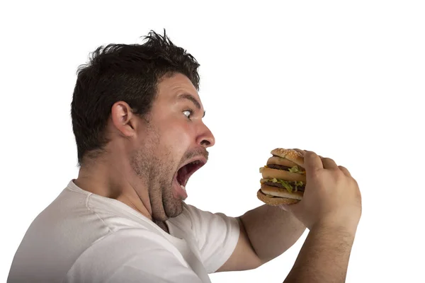 Unersättlicher und hungriger Mann isst ein Sandwich — Stockfoto