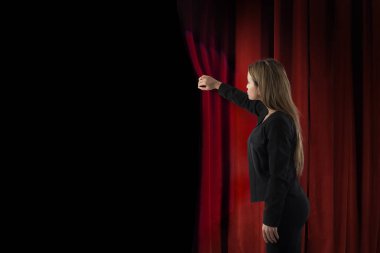 Woman open red curtains of the theater stage clipart