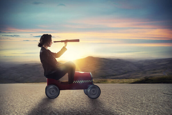 Businesswoman with telescope on a car looks for new business opportunity