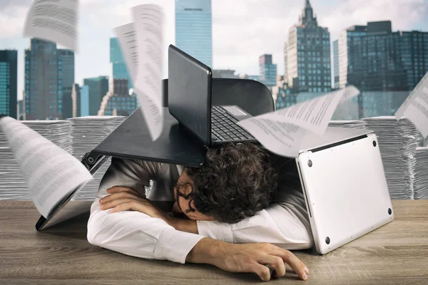 Hombre de negocios cansado durmiendo bajo una pila de computadoras portátiles debido a la carga de trabajo — Foto de Stock