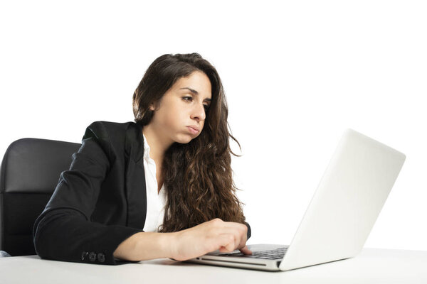Bored woman snorts in the office while working on the laptop