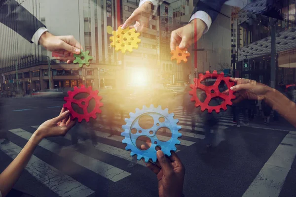 Business team connect pieces of gears. Teamwork, partnership and integration concept. Double exposure — Stock Photo, Image