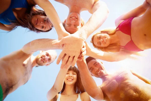 Happy group of friends give five in circle under the sun — Stock Photo, Image