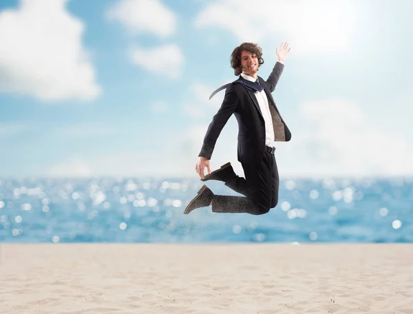 Businessman jumps on the sand. Concept of vacation — Stock Photo, Image