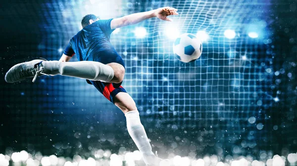 Football scene at night match with player kicking the ball with power — Stock Photo, Image
