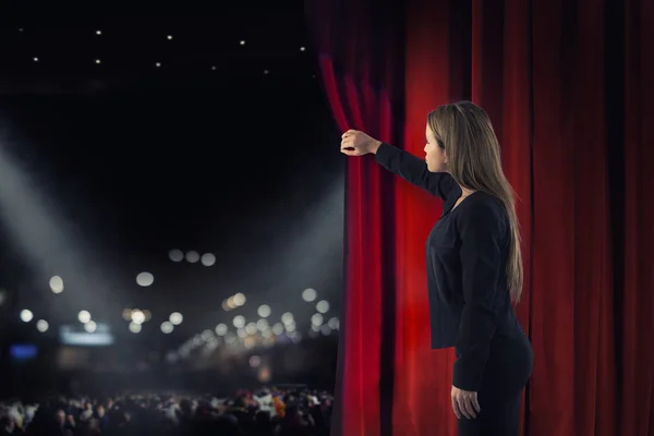 Woman open red curtains of the theater stage — Stock Photo, Image