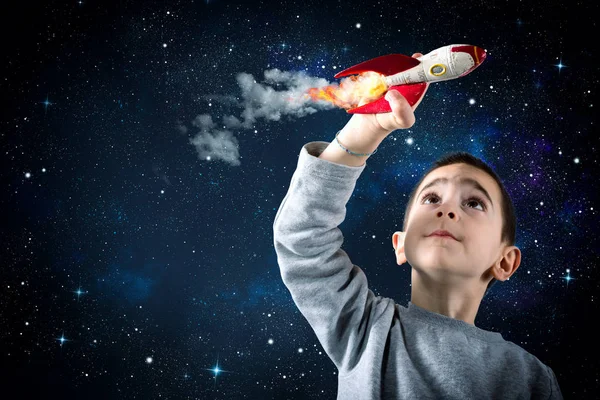 Child plays with a rocket. Concept of imagination — Stock Photo, Image