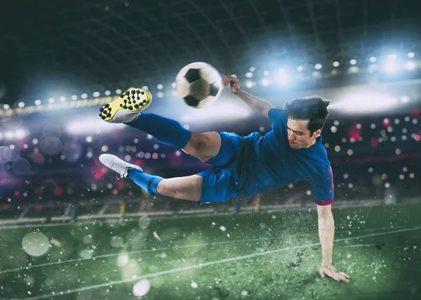 Football scene at night match with player kicking the ball with power. — Stock Photo, Image