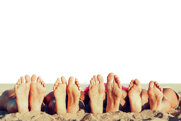 Group of friends having fun on the beach with their foots. Concept of summertime. Isolated on white background