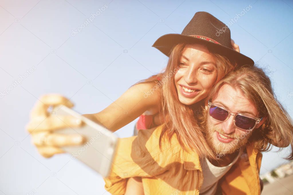 Happy group of friend makes a selfie with a mobile phone.