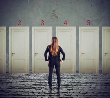 Businesswoman looking to select the right door. Concept of confusion and competition clipart