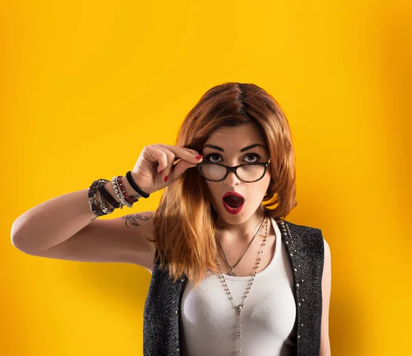 Girl has a shocked expression on yellow background — Stock Photo, Image