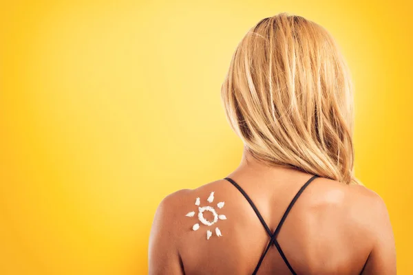 Girl in swimsuit with a sun made with sunscreen. — Stock Photo, Image