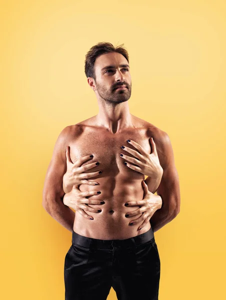 Sexy man touched by multiple woman hands — Stock Photo, Image