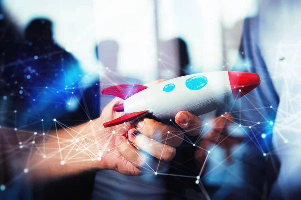 Businessman launches his startup company. Hand holding a toy rocket. double exposure with network effects — 스톡 사진