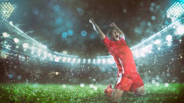 Kırmızı üniformalı futbolcu stadyumdaki zafere seviniyor.