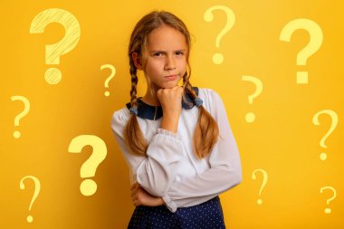 Young student has some doubt about something. yellow background clipart
