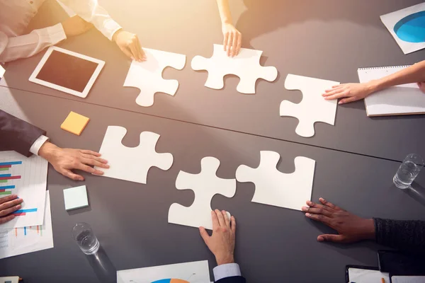 Teamwork of partners. Concept of integration and startup with puzzle pieces — Stock Photo, Image