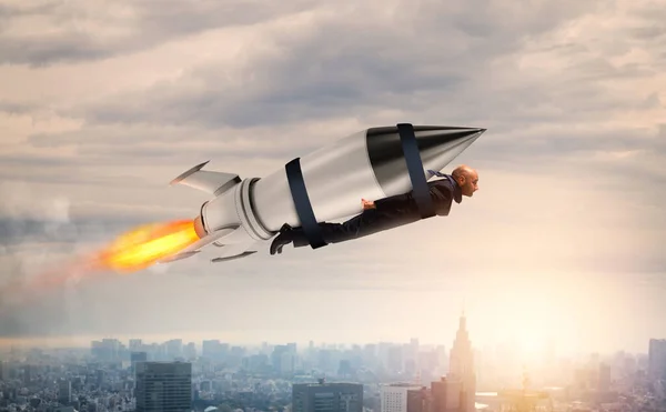 Businessman flies with a fast rocket. Concept of ambition and determination — Stock Photo, Image