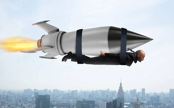 Businessman flies with a fast rocket. Concept of ambition and determination — Stock Photo, Image