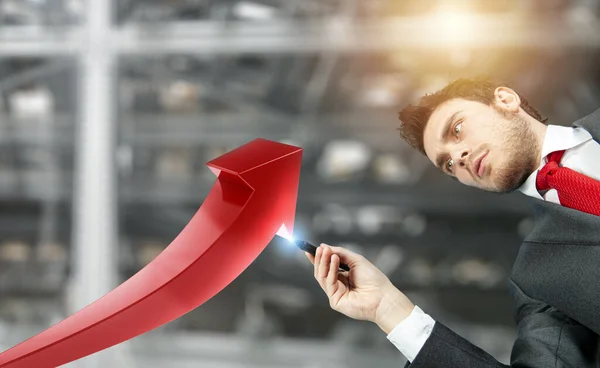 Businessman draws a growing red arrow of statistic — Stock Photo, Image