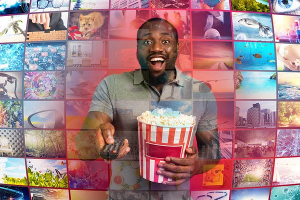 Man has fun watching a film. Concept of entertainment and streaming tv. red background — Stock Photo, Image
