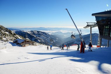 JASNA, SLOVAKIA - JANUARY 23:  The skiers and Rotunda cableway station on Chopok in Jasna Low Tatras. It is the largest ski resort in Slovakia with 49 km of pistes on January 23, 2017 in Jasna, Slovakia clipart