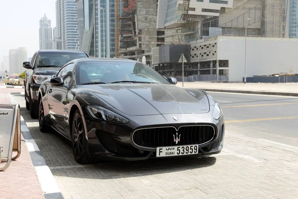 DUBAI, UAE - SEPTEMBER 10: The luxury Maserati Granturismo car is near luxury hotel on September 10, 2013 in Dubai, United Arab Emirates. Hotels in Dubai attracted over 11 million guests in 2013. — Stock Photo, Image