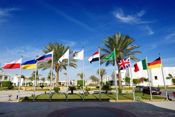 SHARM EL SHEIKH, EGYPT -  NOVEMBER 30: The parking with Egyptian, British, Italian, German, Ukrainian, Polish, Russian flags at luxury hotel on November 30, 2012 in Sharm el Sheikh, Egypt. Up to 12 million tourists have visited Egypt in year 2012. — Stock Photo, Image
