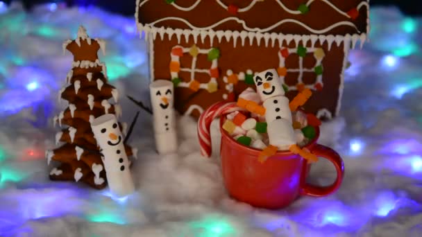 手工制作的可食用姜饼屋 棉花糖雪人 新年树 雪装饰 花环雪和背景照明 — 图库视频影像