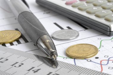 Para, hesap makinesi, grafik ve kalem ile mali geçmiş.