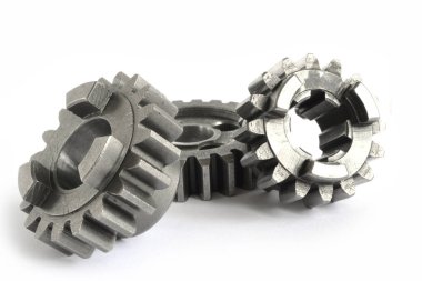 Beyaz arka planda üç yakın çekim metal dişli..