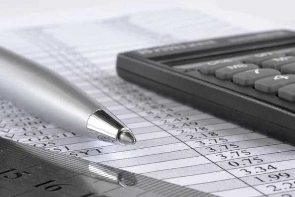 Business background with table, pen and calculator.