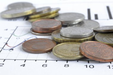Farklı sikke ve grafik ile finansal arka plan.