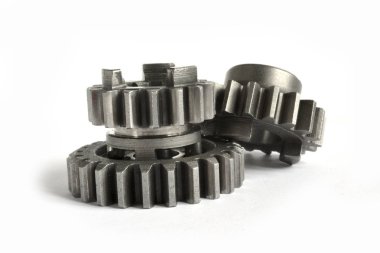 Beyaz arka planda üç yakın çekim metal dişli..