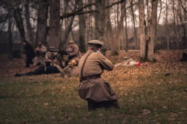Estonian soldier attacking in the forest. 1918 year