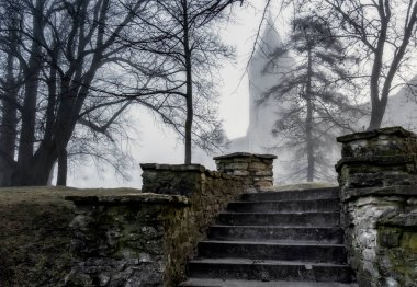 bishop's castle in the morning fog. Estonia, Haapsalu city clipart