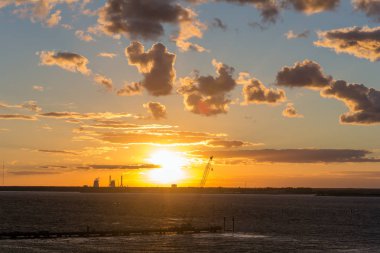 Şantiye su üstünde parlak günbatımı