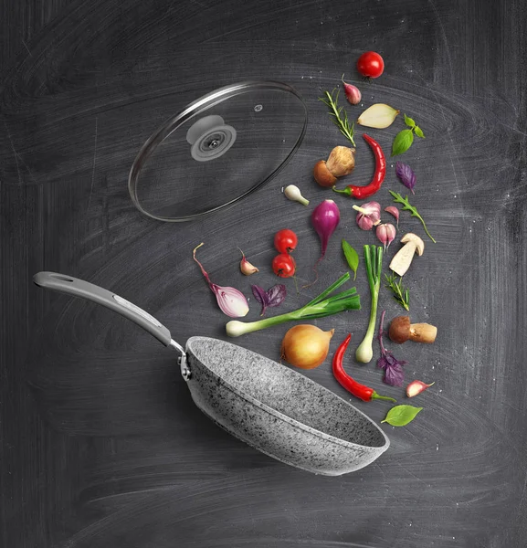 Vegetable composition. Frying pan with a lid and flying vegetables, on a school board