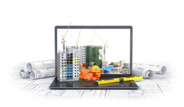 Bir dizüstü bilgisayar, gökdelen, çizim planı, yapı malzemeleri ekranında inşaat sitesi. 3D çizim
