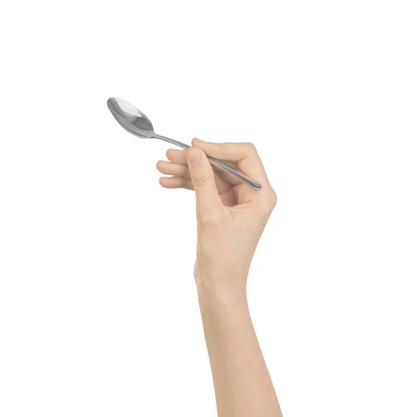 Zilveren lepel in vrouwen hand geïsoleerd — Stockfoto