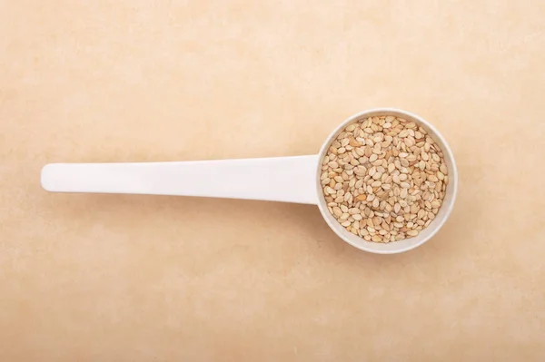 Sesame Measuring Spoon Brown Background — Stock Photo, Image