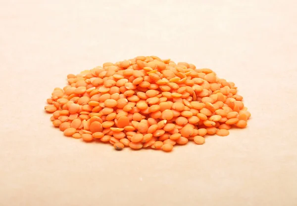 Red lentils on brown background — Stock Photo, Image