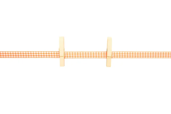 Background with orange-white checkered ribbon and pegs — Stock Photo, Image